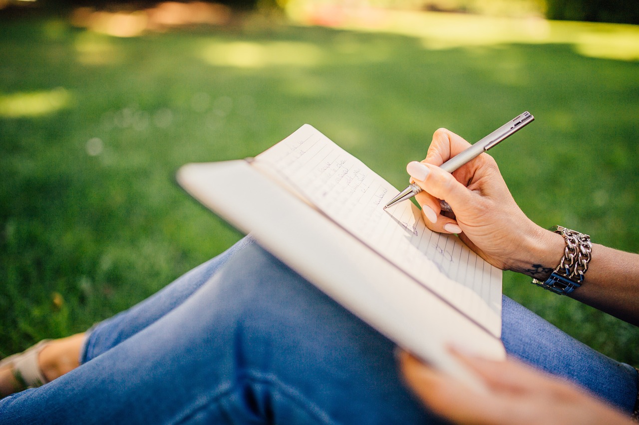 writing, writer, notes, pen, notebook, book, girl, woman, people, hands, grass, nature, outdoors
